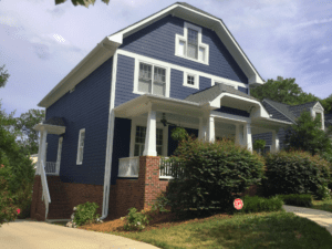 Side view of the house in blue color with plants in front