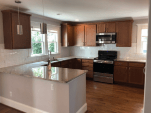 The open kitchen area of the house with cabinets and sink