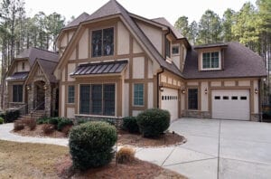 Close view of a house with brown color and plants in front