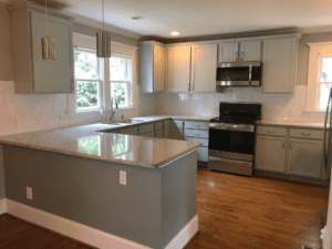 Open kitchen area with white cabinets and a glass window