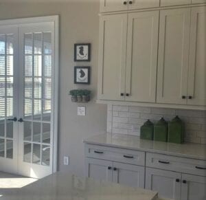 White Cabinets with two frames on the wall