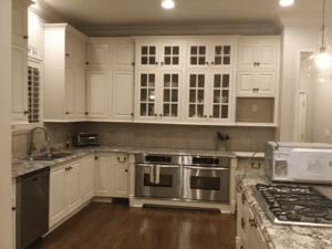 The kitchen area of the house with white cabinets