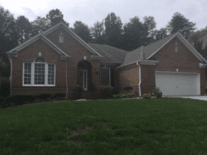 Brown house with green grass in front