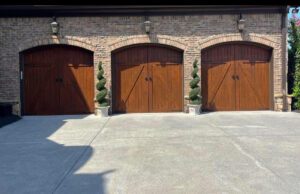 Three brown wooden garage doors.