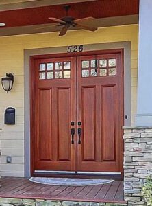 Double wooden doors with glass panels.