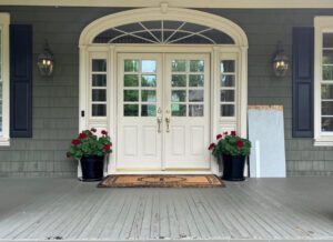 Front porch with double doors and plants.