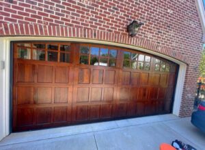 Wooden garage door with glass panels.