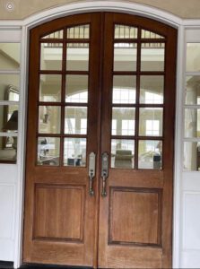 Double wooden doors with glass panels.