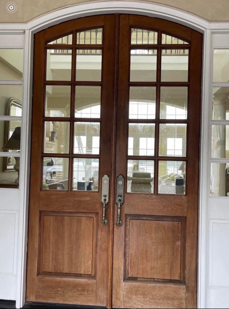 Arched oak double doors with interior reflection