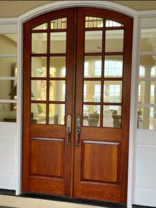 Double wooden doors with glass panels.