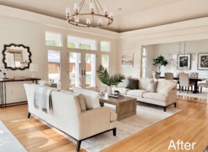 White living room with a large window and couch.