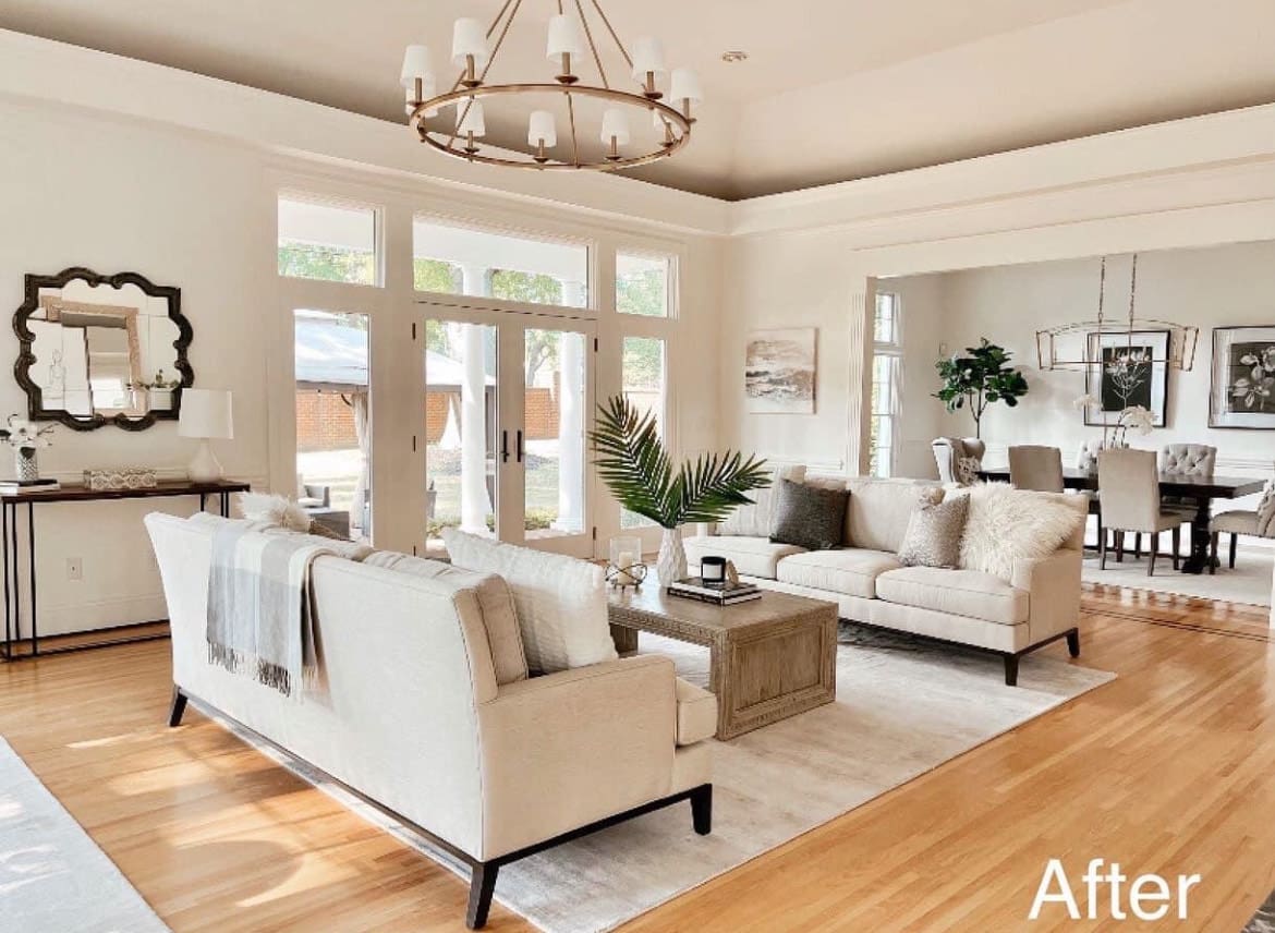 White living room with a large window and couch.