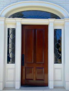 White door with stained glass panels.