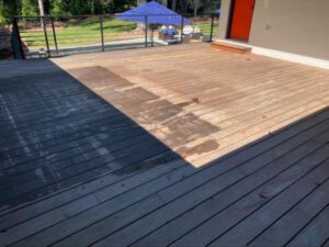 A wooden deck with a shadow line.