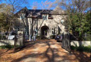 A large house with a gated driveway.