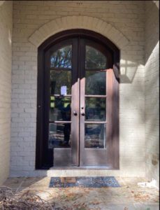 Arched double doors with glass panels.