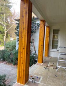 Wooden porch columns stained golden brown.