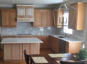 Kitchen with wood cabinets and a chandelier.