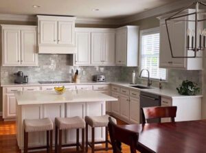 White kitchen with island and dining table.