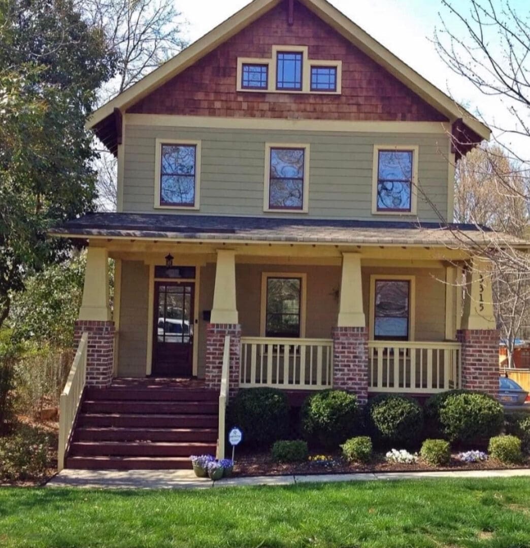 Yellow Craftsman home with brick porch steps
