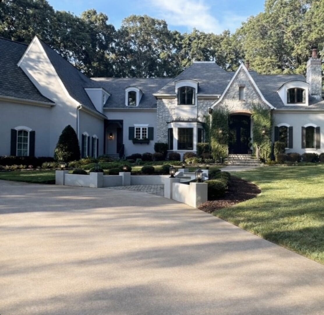 Large stone-faced house with circular driveway