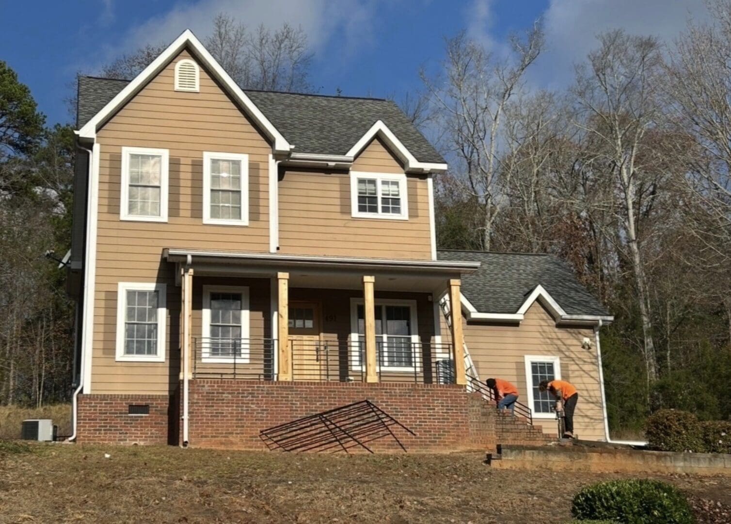 Gray home with brick base and porch