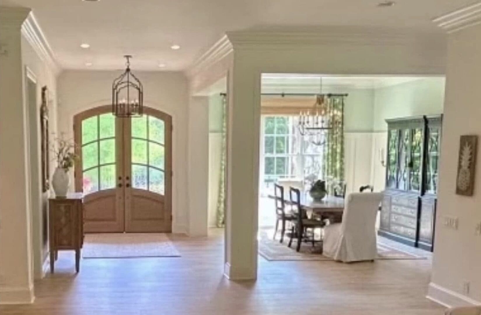 Bright foyer opening to dining room chandelier