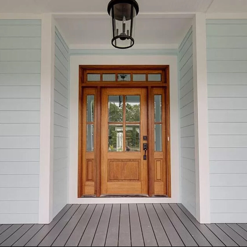 Brown wooden front door porch with pale green walls